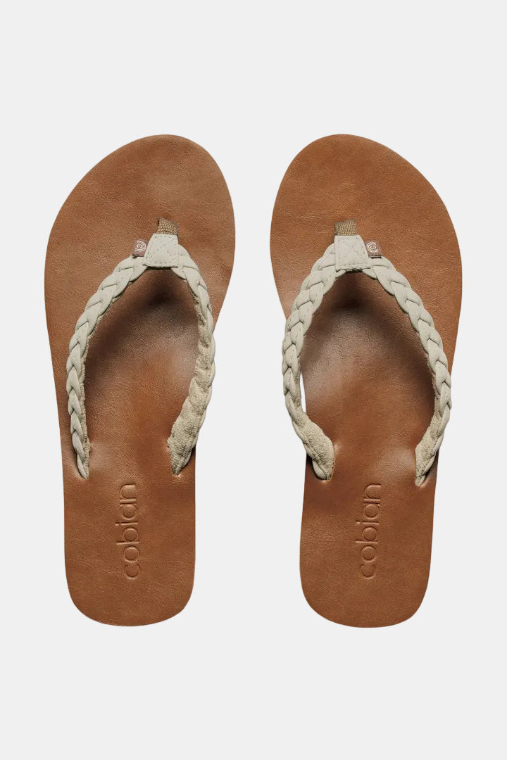 Pair of brown sandals with braided straps on a white background