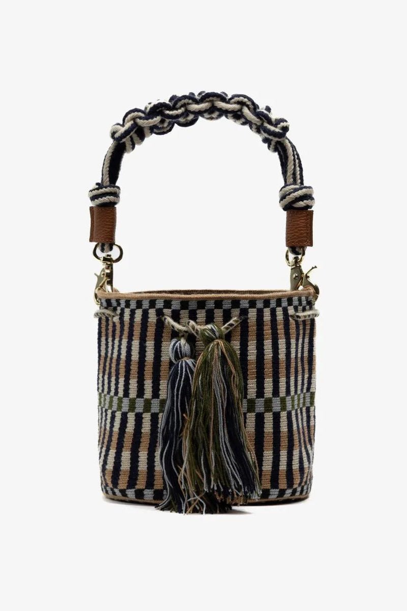 Textured handbag with braided handle and tassel on a white background