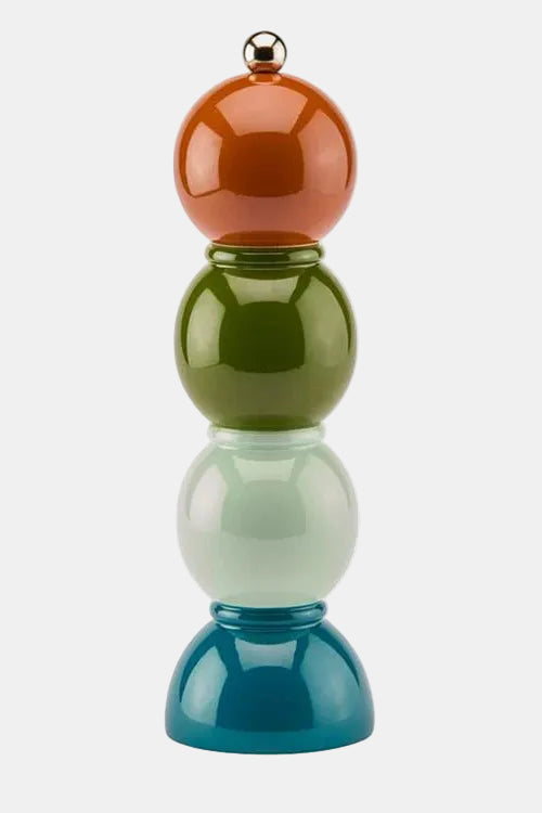 Colorful cylindrical object with three different colored spheres stacked on a white background