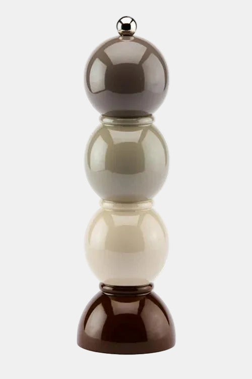 Decorative object with stacked spherical shapes in brown, beige, and white on a white background
