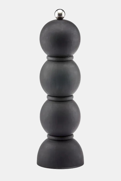 Black pepper grinder with a silver top on a white background