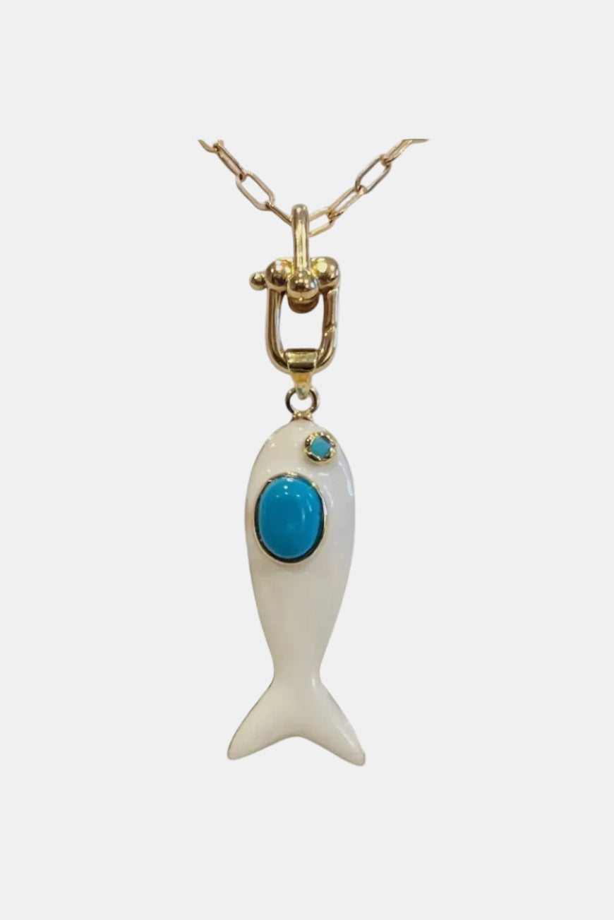 Fish-shaped pendant with turquoise stone on a gold chain against a white background