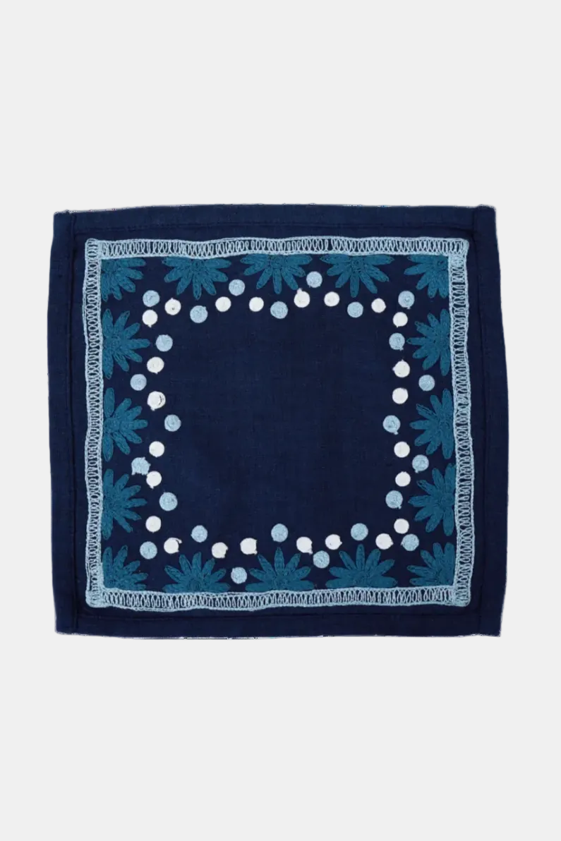 Navy blue fabric with white polka dot border and blue floral patterns on a white background