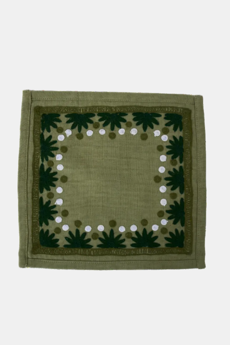 Green fabric square with leaf and dot pattern on a white background