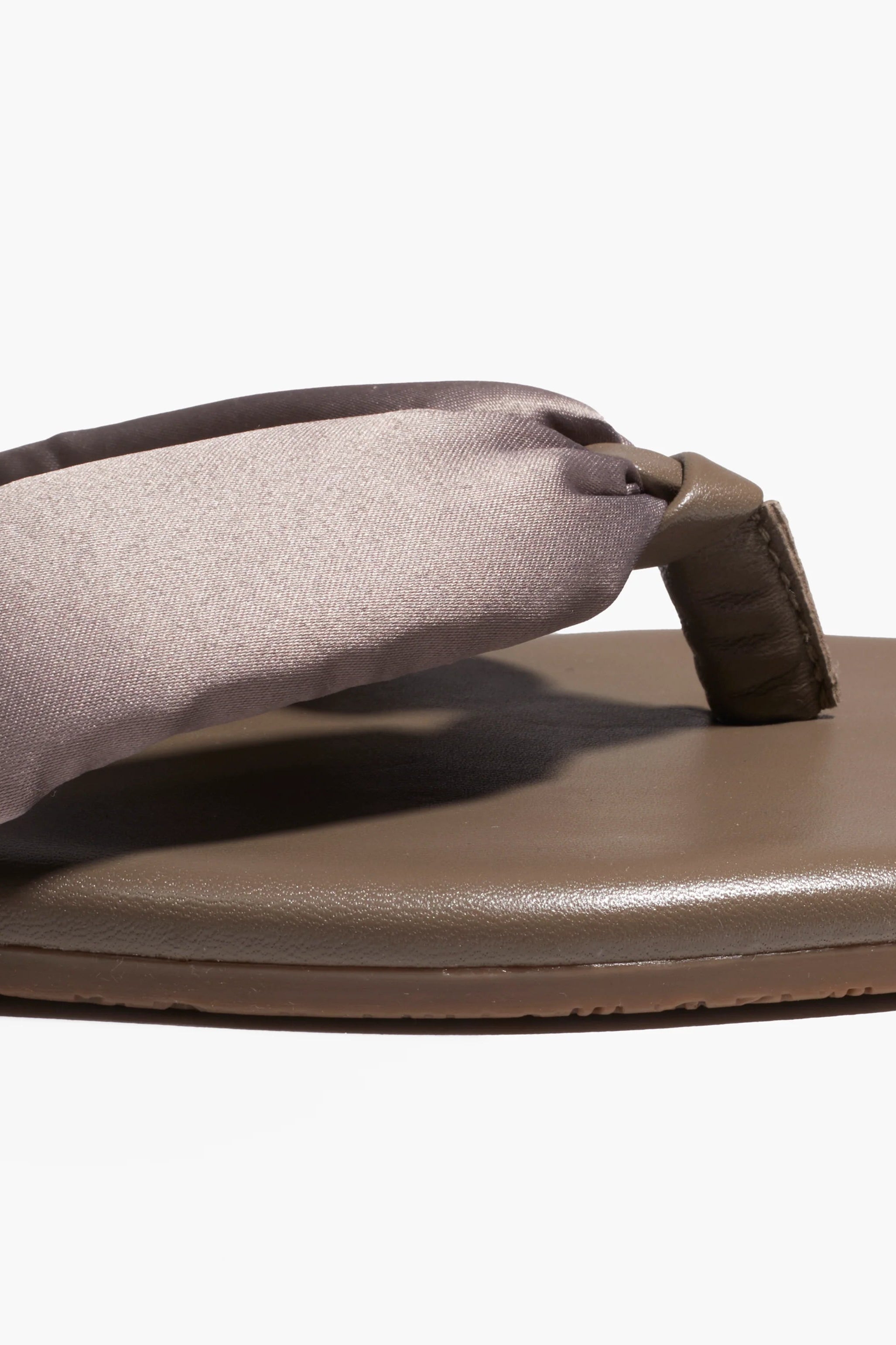 Brown sandal with a gray insole on a white background