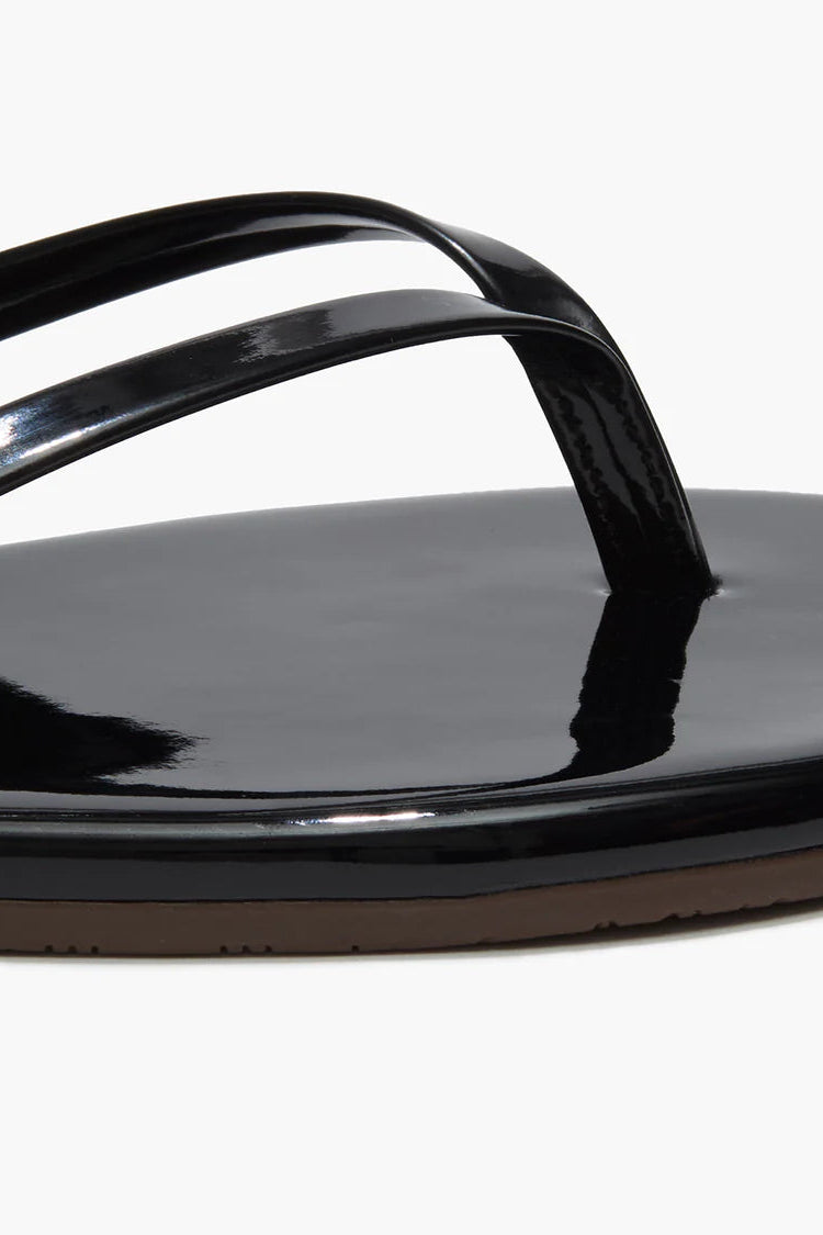 Black sandal with a strap on a white background
