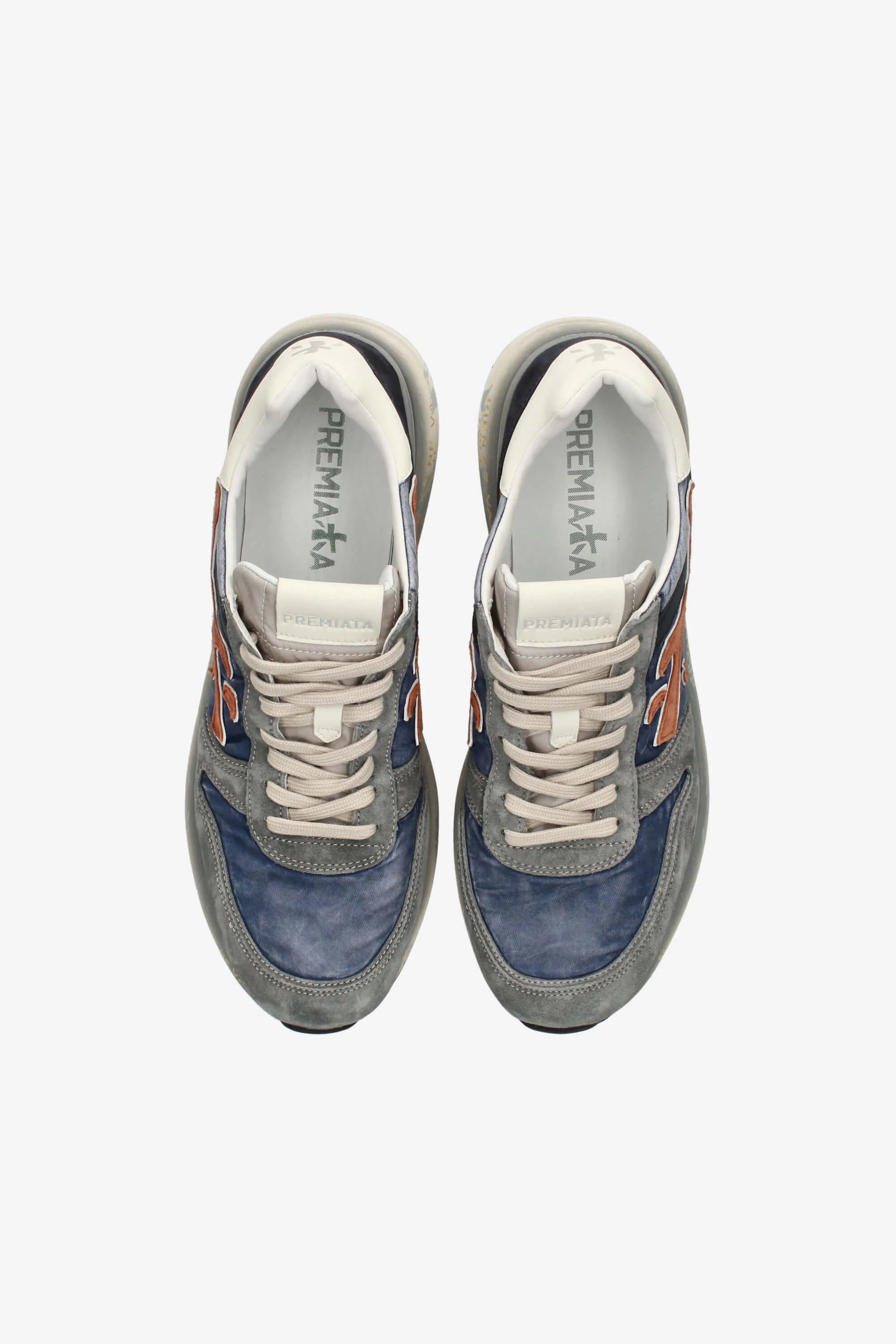 Pair of blue and gray sneakers with white soles on a white background