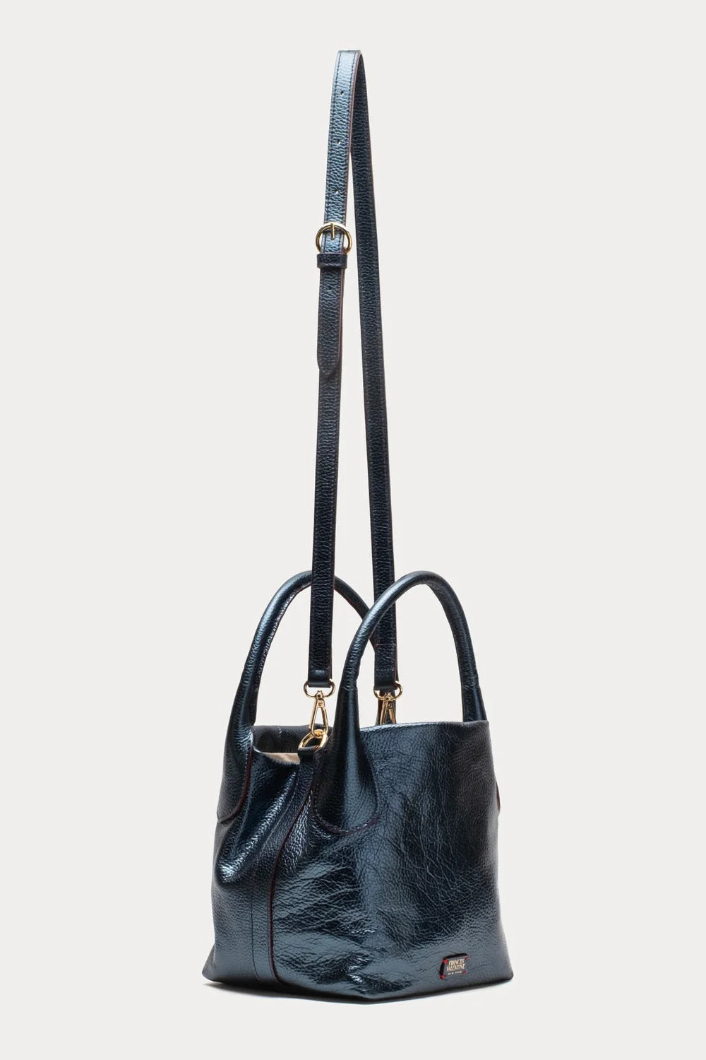 A dark navy blue leather handbag with a textured finish, featuring double top handles, a long shoulder strap, and gold-tone hardware, shown against a light gray background.