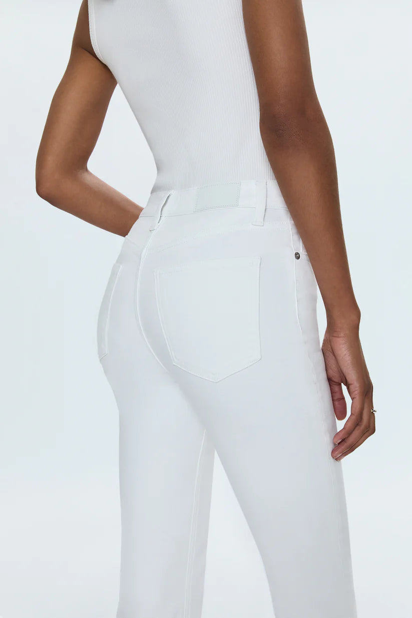 Person wearing a white bodysuit and pants on a light gray background