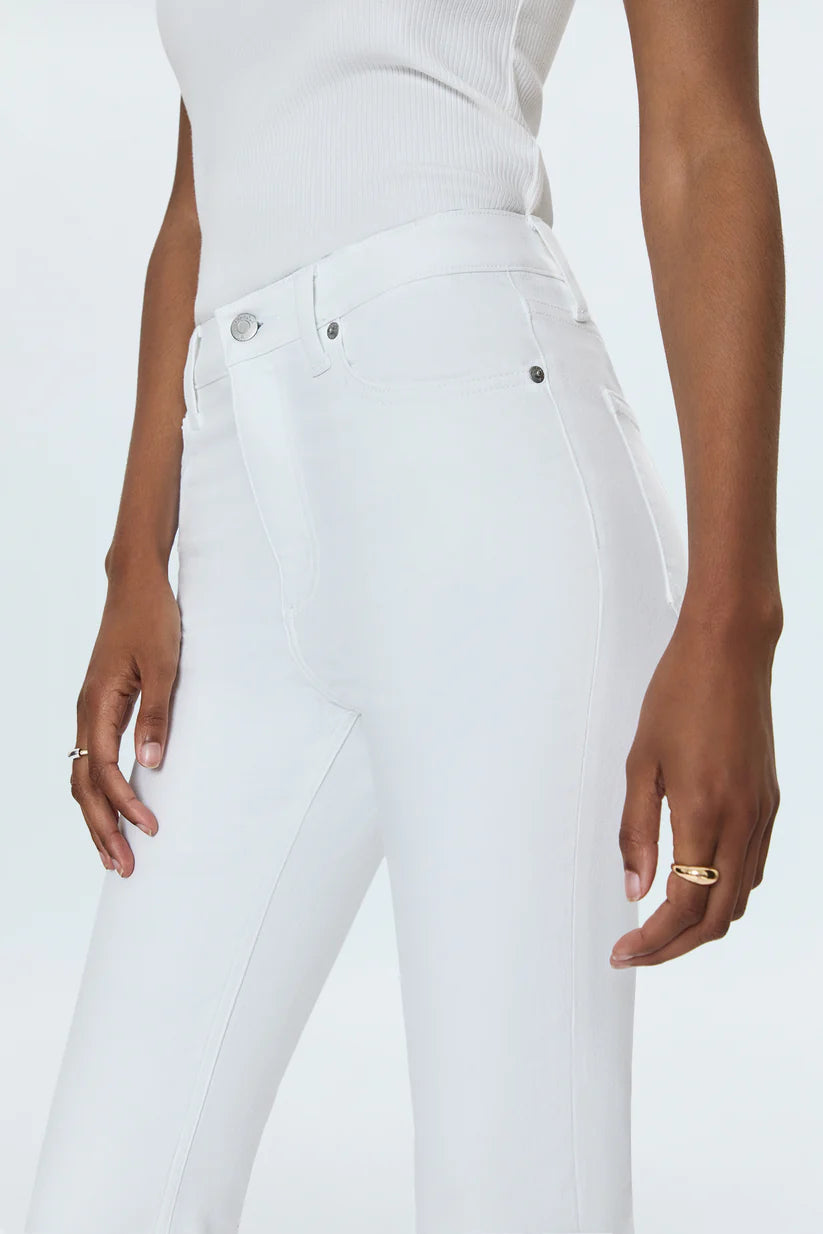 Person wearing white jeans on a plain background