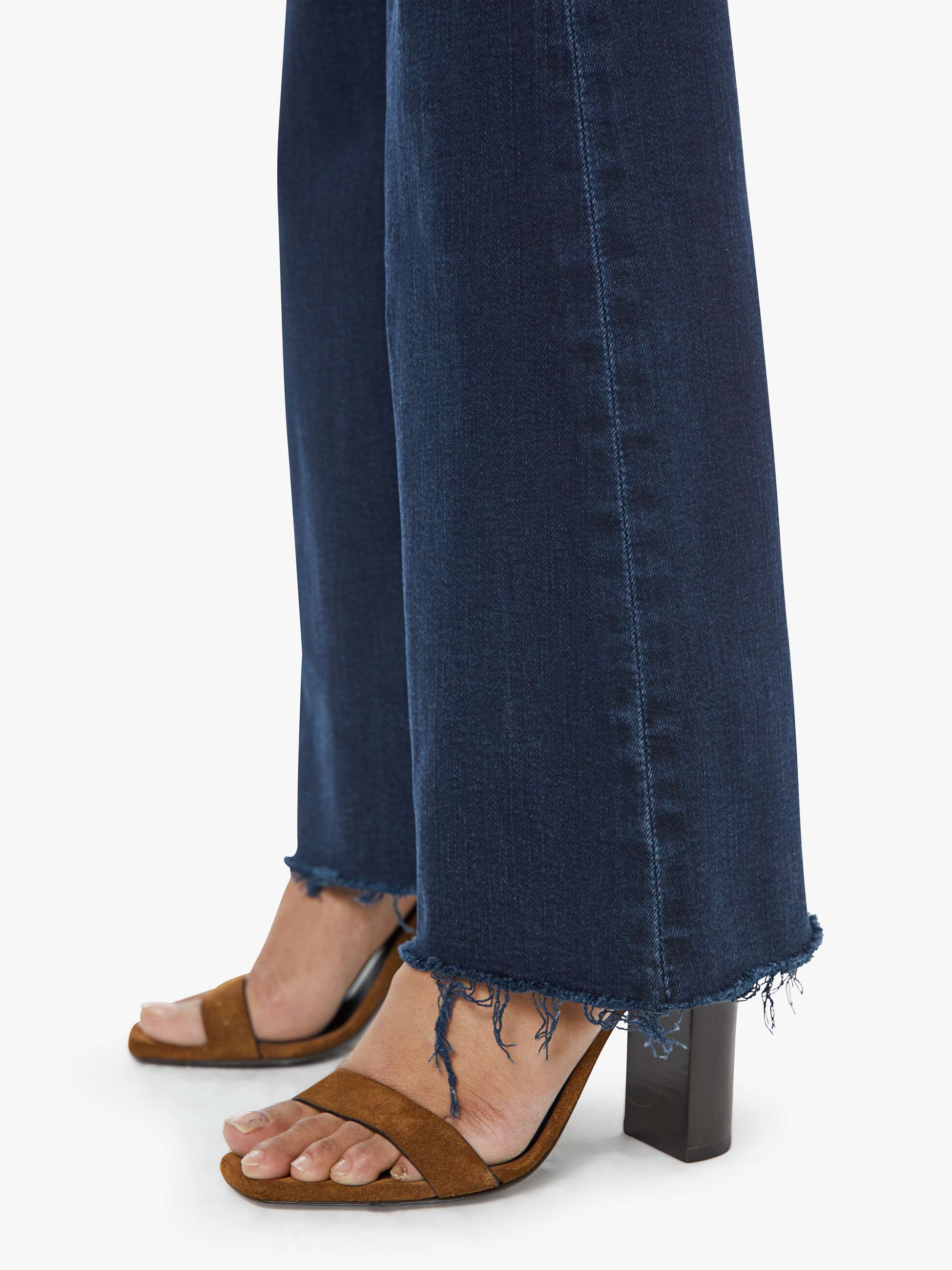 Close-up of blue jeans with a white background