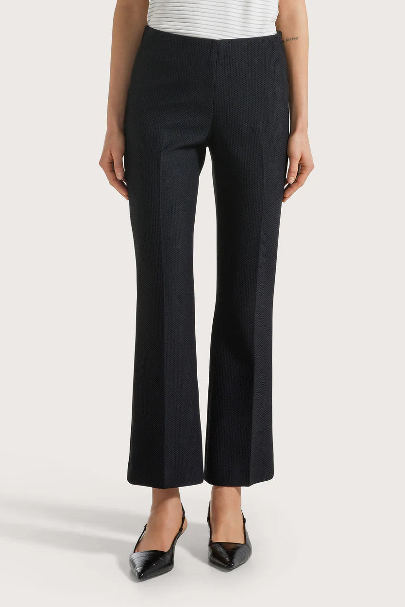 Person wearing black pants on a white background