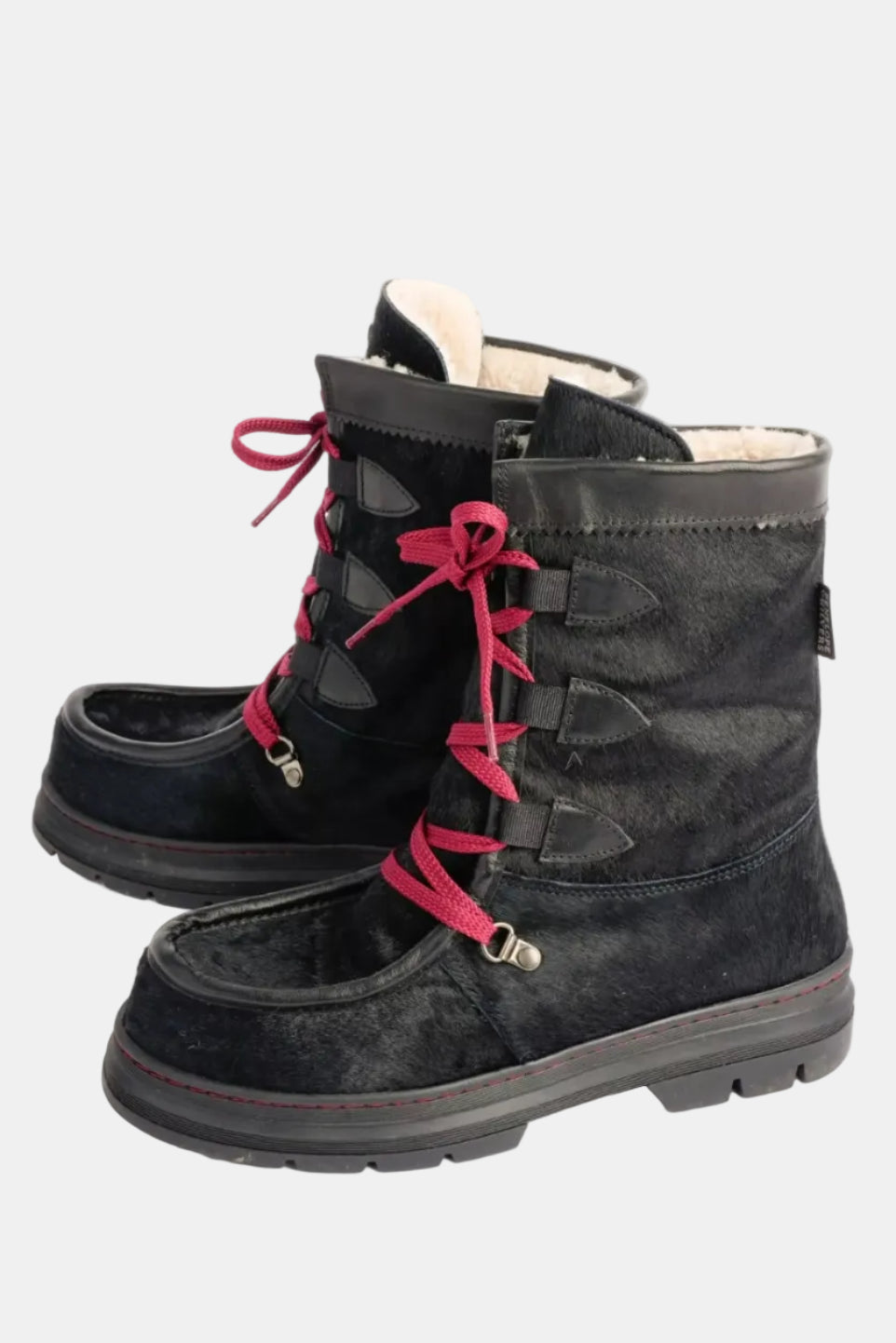 Black winter boots with pink laces on a white background