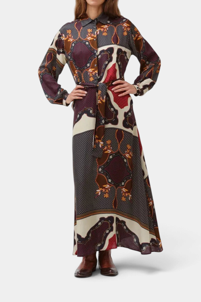 The Copper Shed Riora silk blend midi dress with long sleeves, button-down front, waist tie, and black floral print.