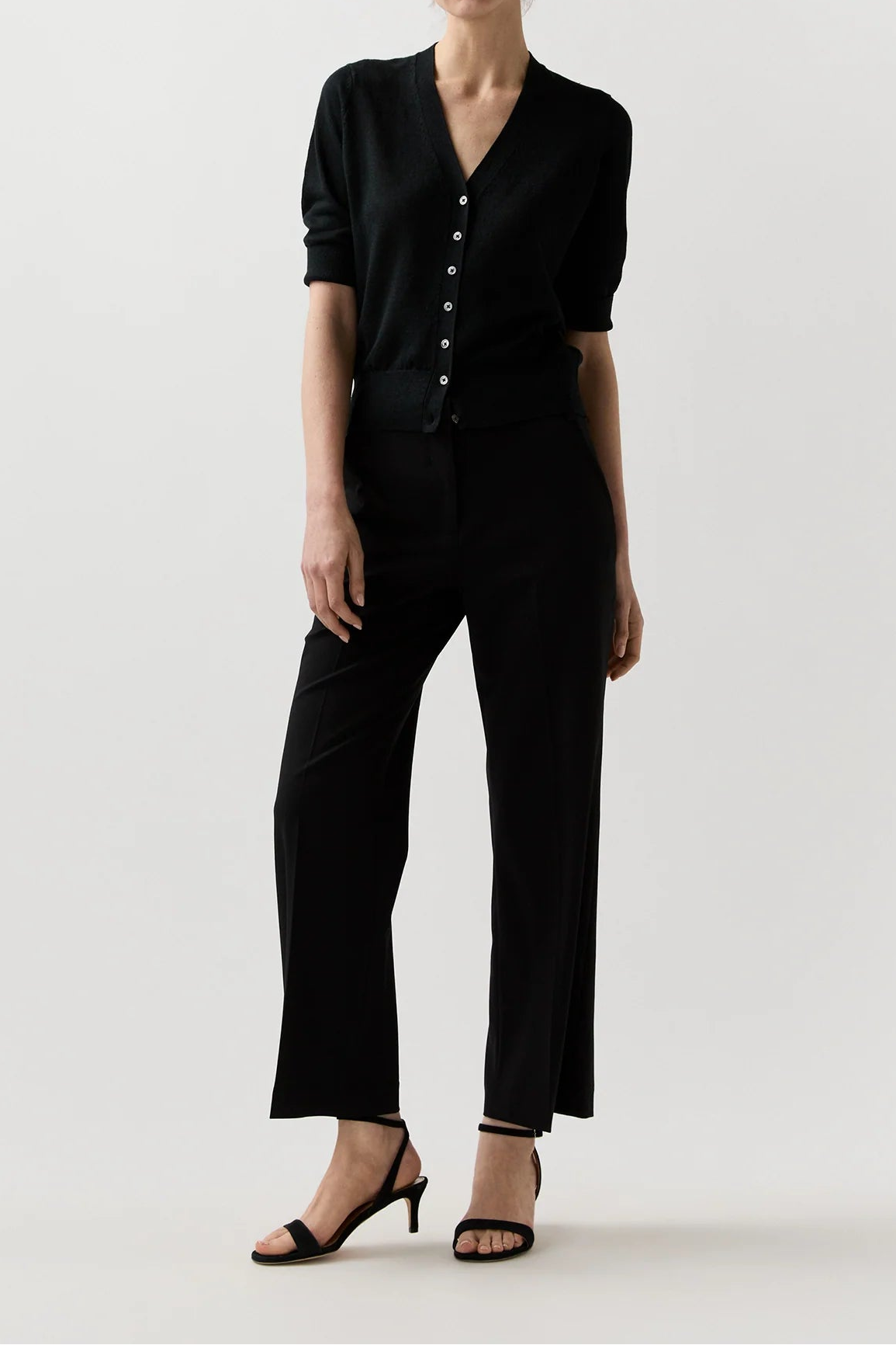 Woman wearing a black outfit on a white background