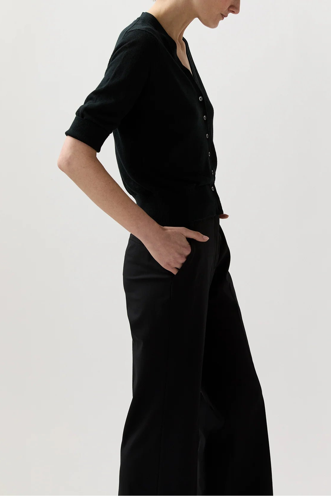 Woman wearing a black dress against a white background