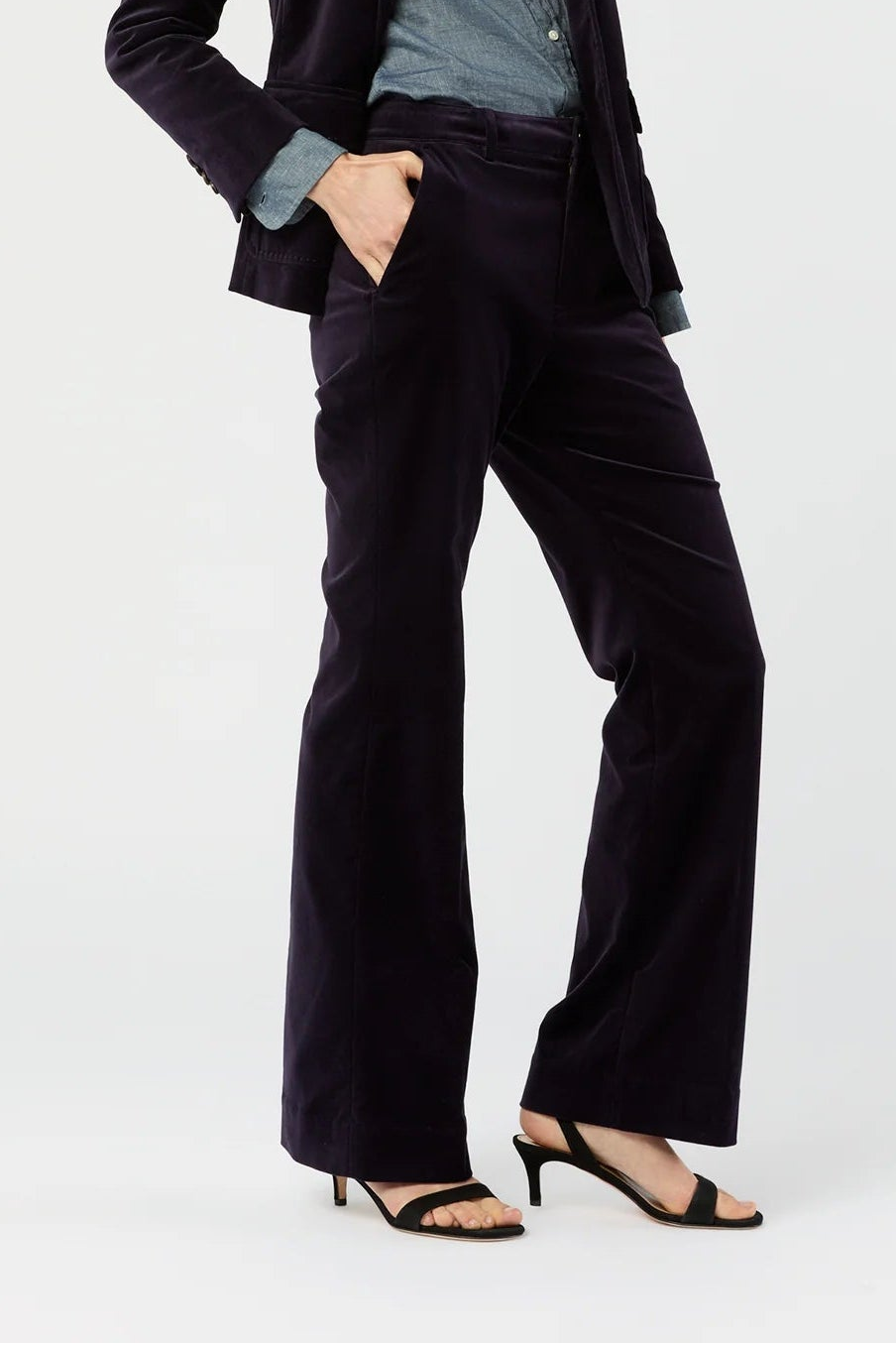Woman wearing a black suit with a white background
