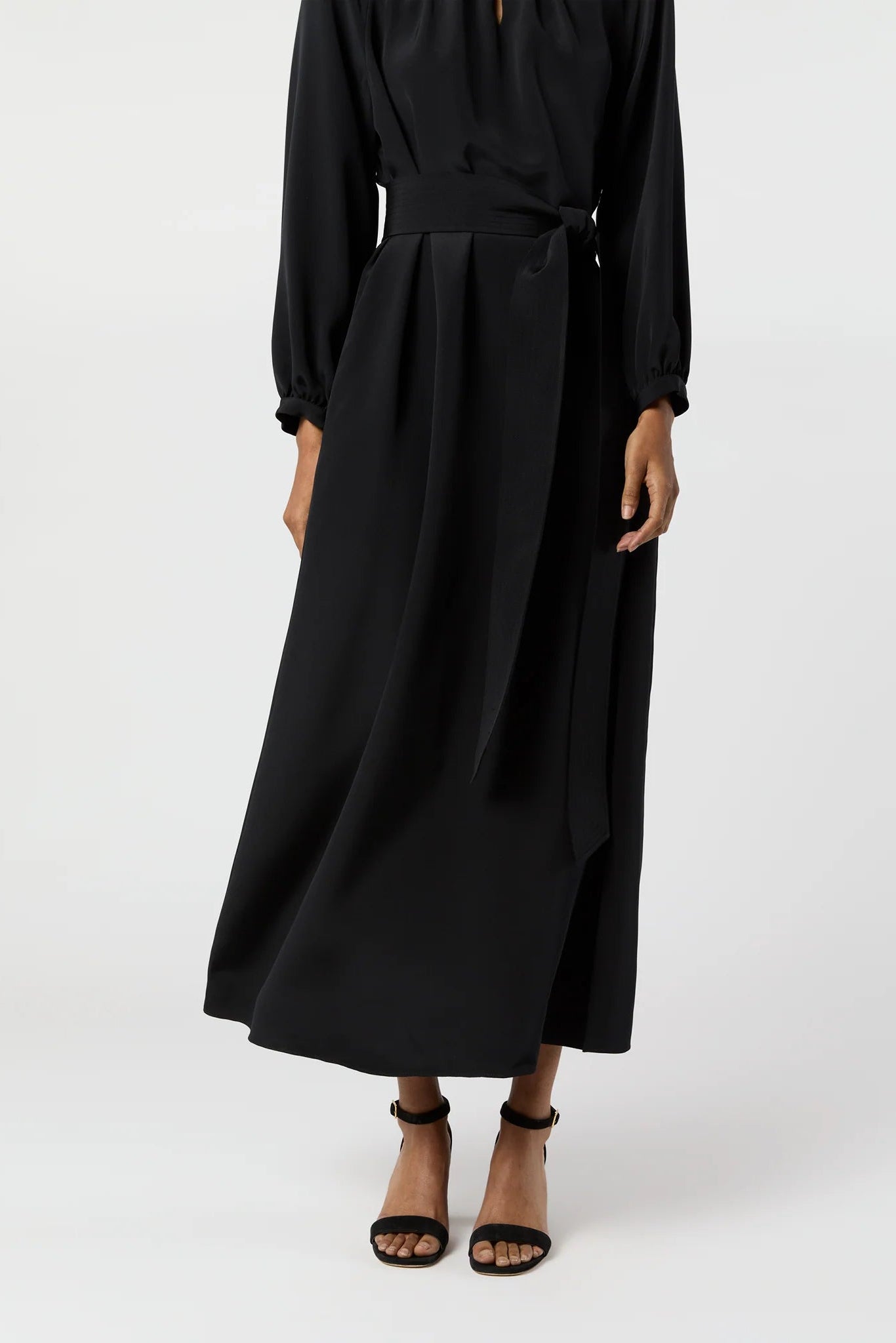 Black dress worn by a person on a white background