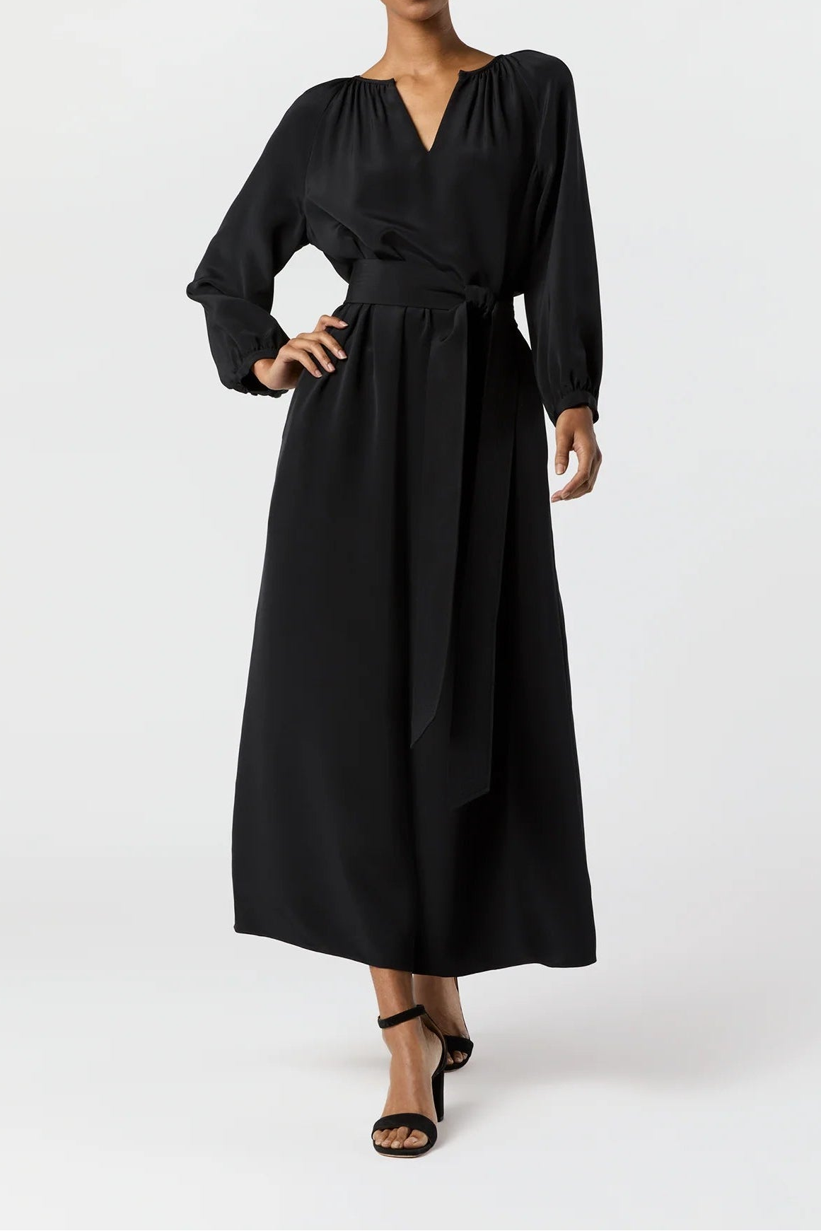 Woman wearing a black dress on a white background