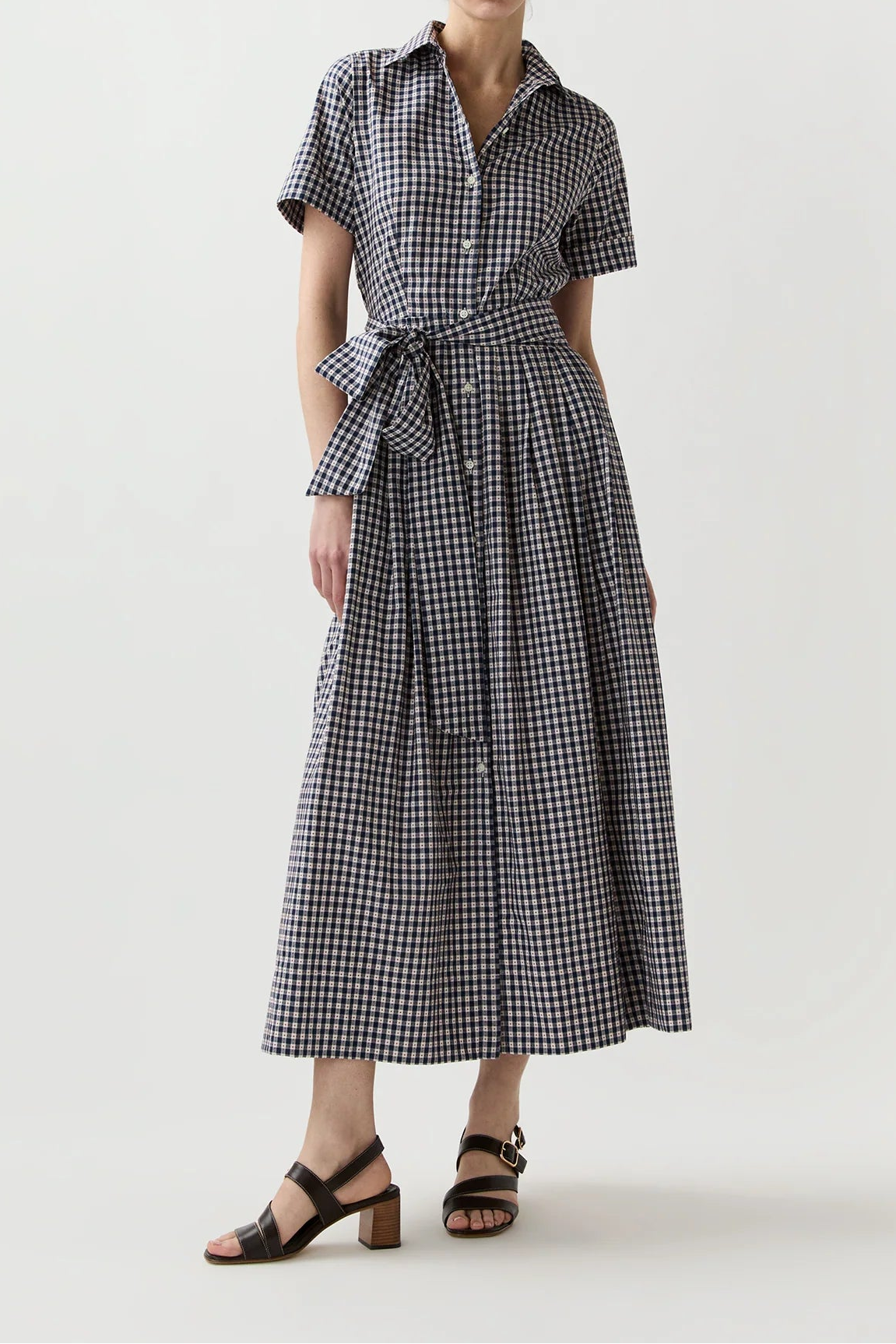 Woman wearing a black and white checkered dress on a white background