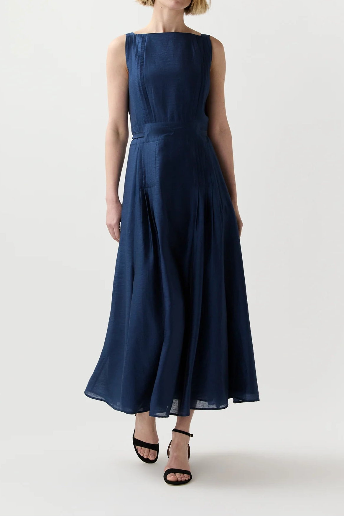 Woman wearing a navy blue dress on a white background