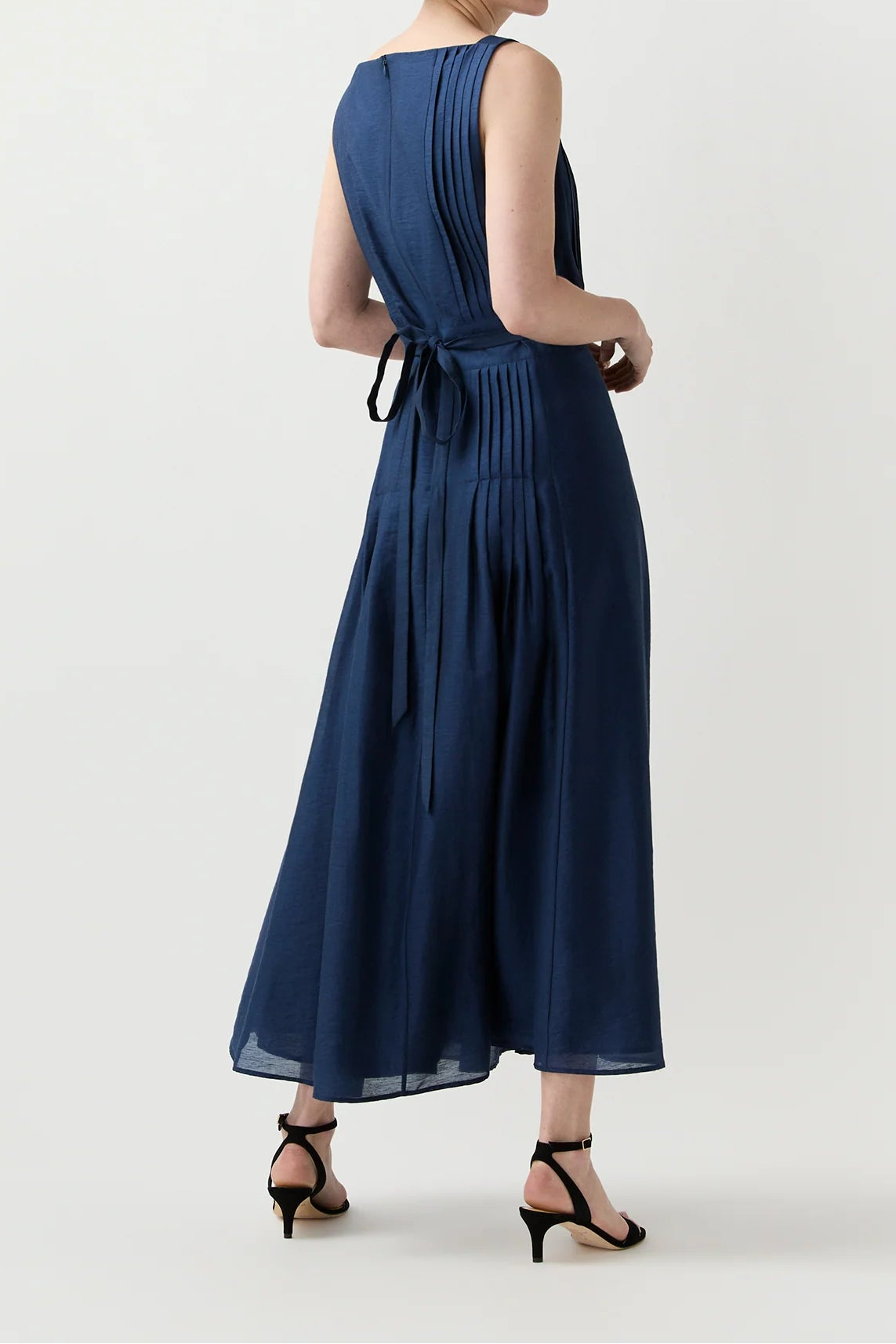 Woman wearing a navy blue dress on a white background