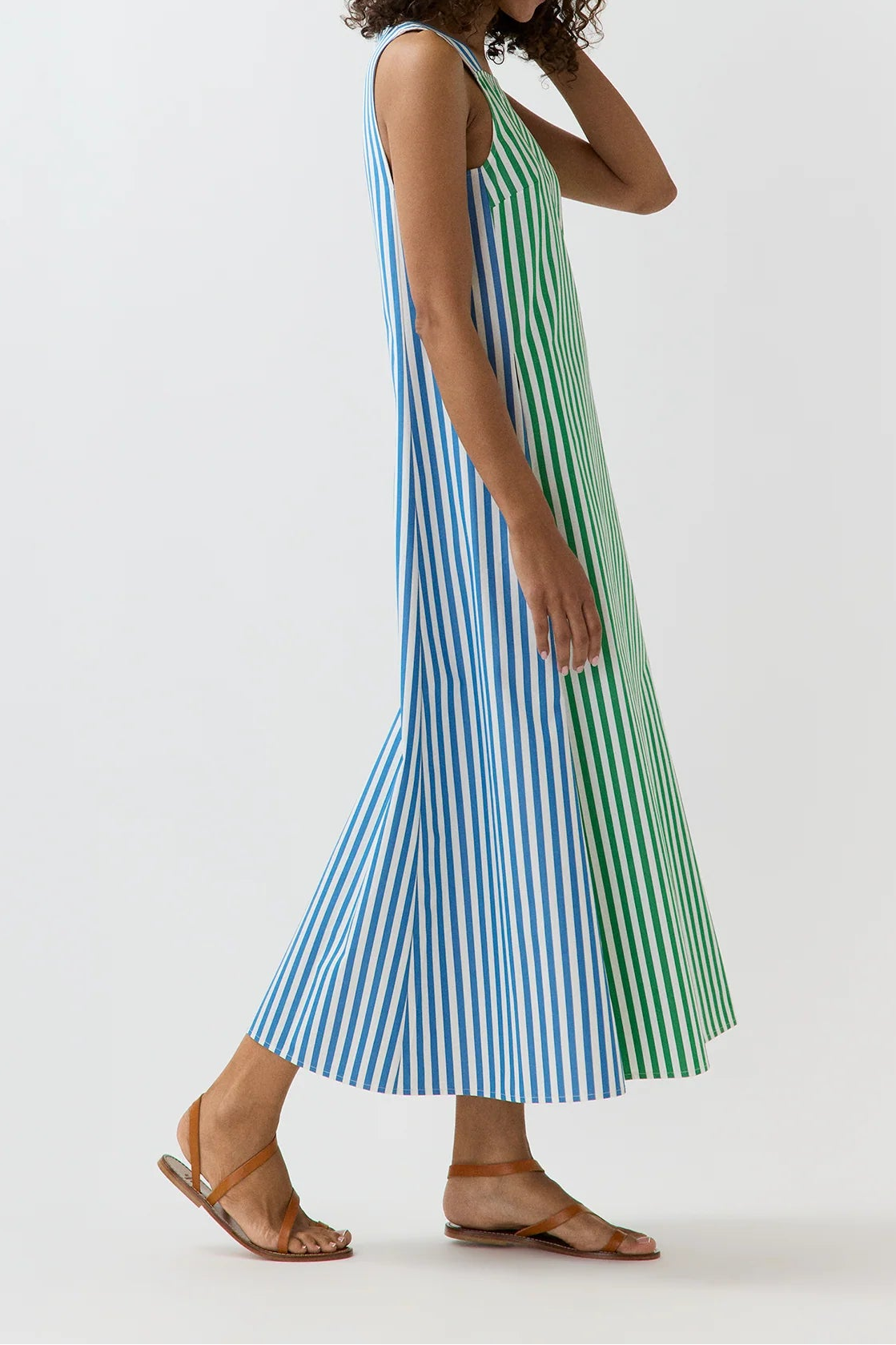Woman wearing a striped dress on a white background
