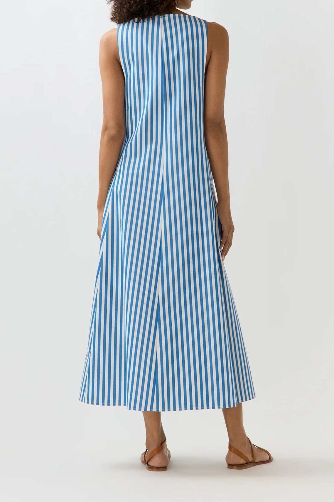 Woman wearing a blue and white striped dress on a white background