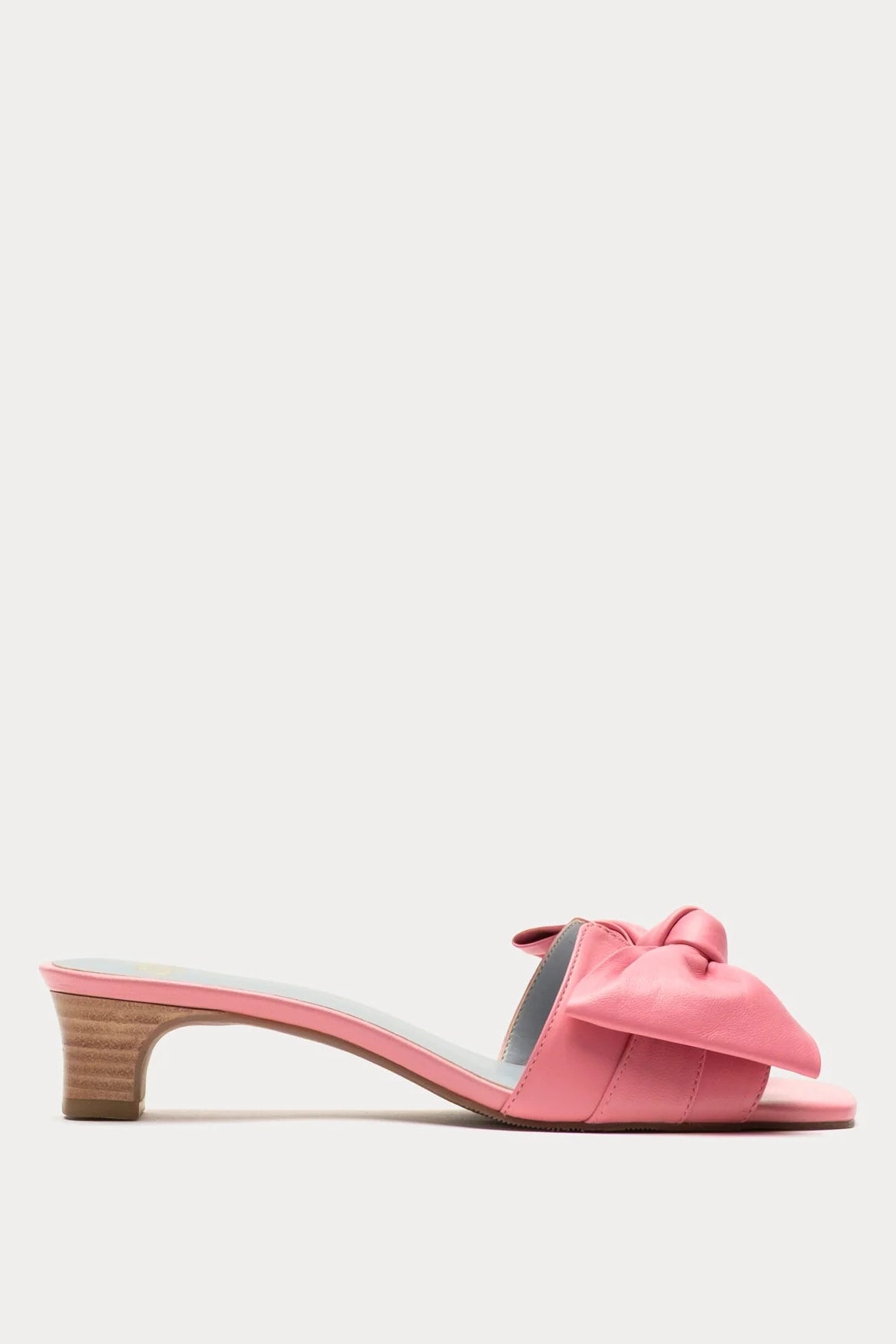 Pink sandal with a bow on a light gray background