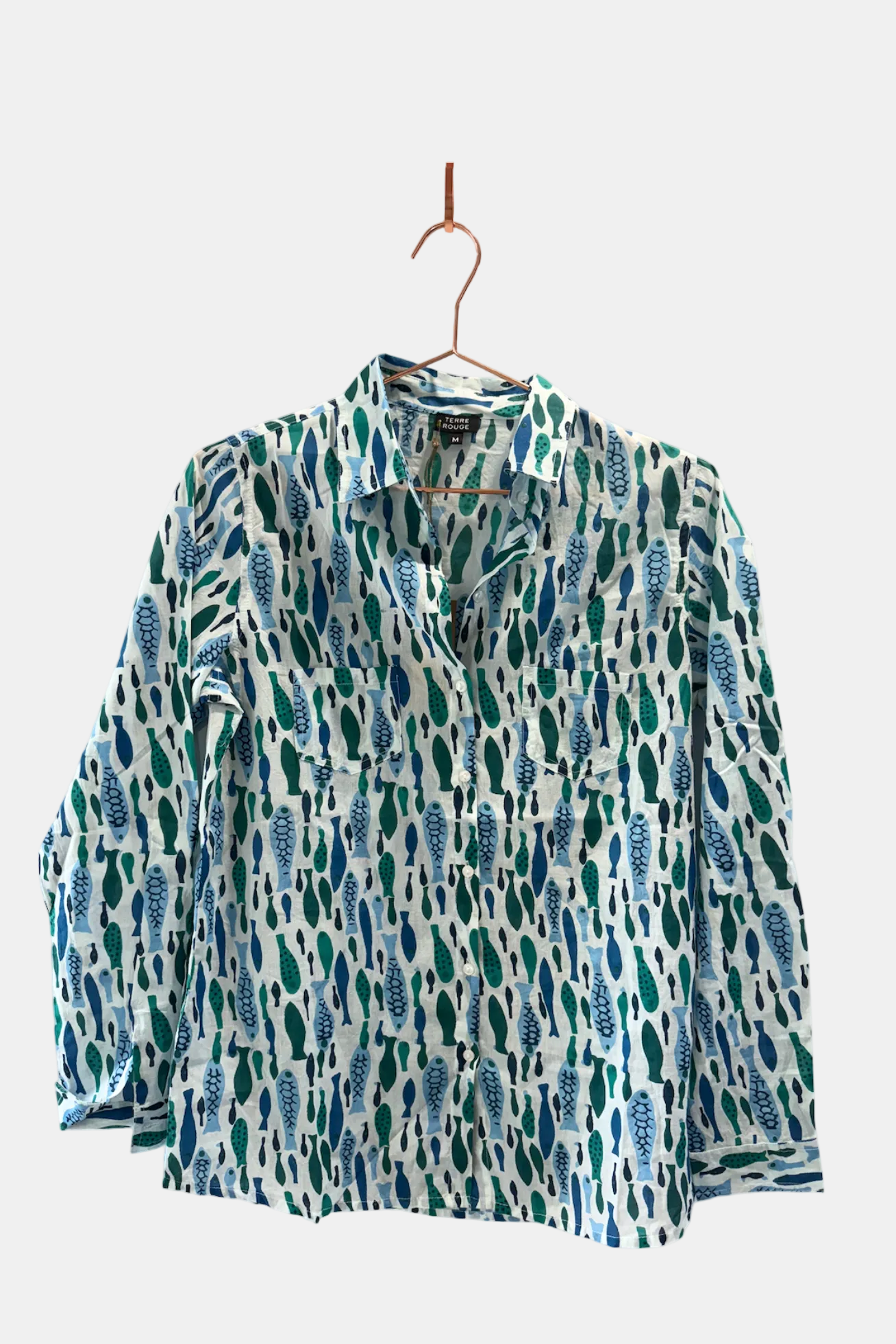 Patterned shirt on a hanger against a white background