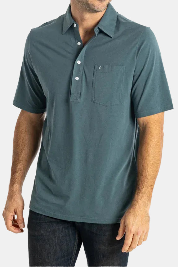 Man wearing a teal polo shirt on a white background