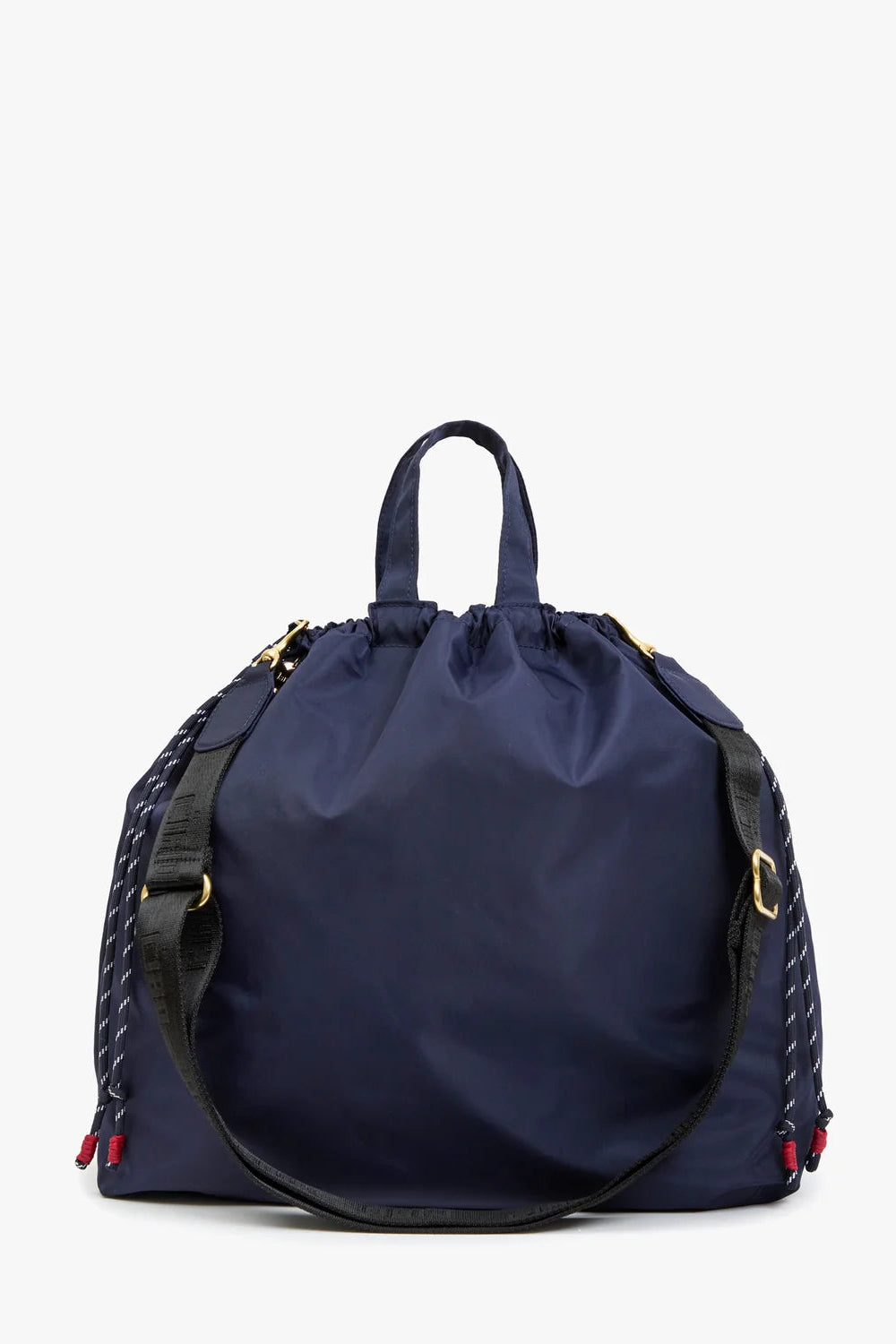A navy blue nylon drawstring bag with black braided side straps, gold-tone hardware, and red and blue tassel accents, shown against a plain white background.