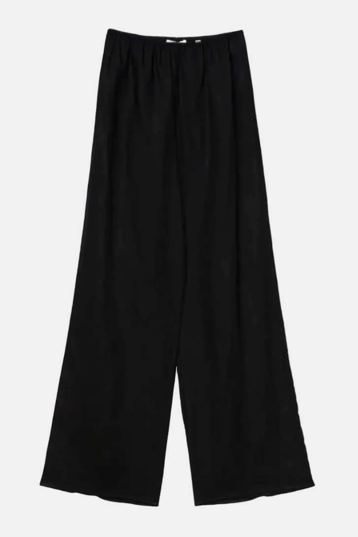 Black wide-leg pants on a beige background
