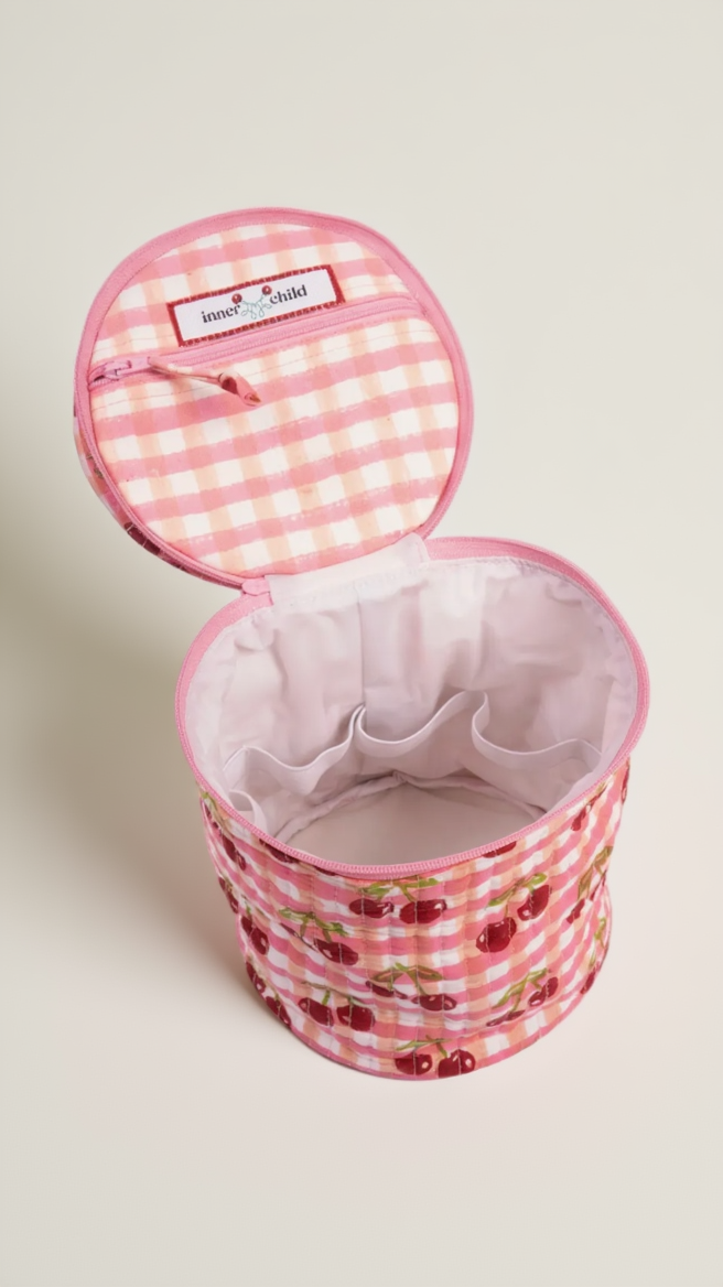 Pink checkered fabric basket with cherry design on a white background