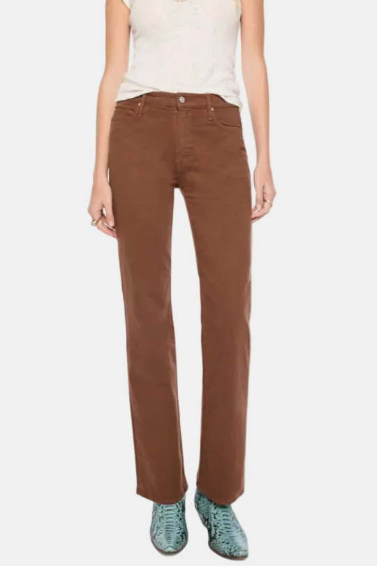 A woman modeling a pair of straight-leg brown corduroy pants, styled with a cream knit top and green snakeskin shoes against a plain white background.