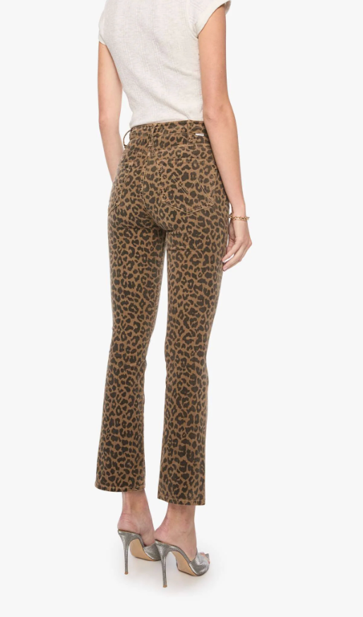 A model shown from the back wearing high-waisted leopard-print ankle-length pants, a light beige sleeveless top, and metallic silver high heels against a plain white background.