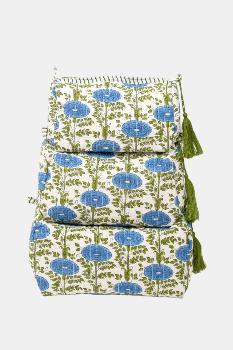 Floral patterned bag with tassels on a white background