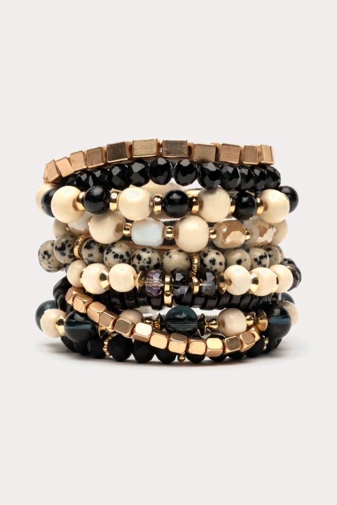 Stack of beaded bracelets on a light gray background
