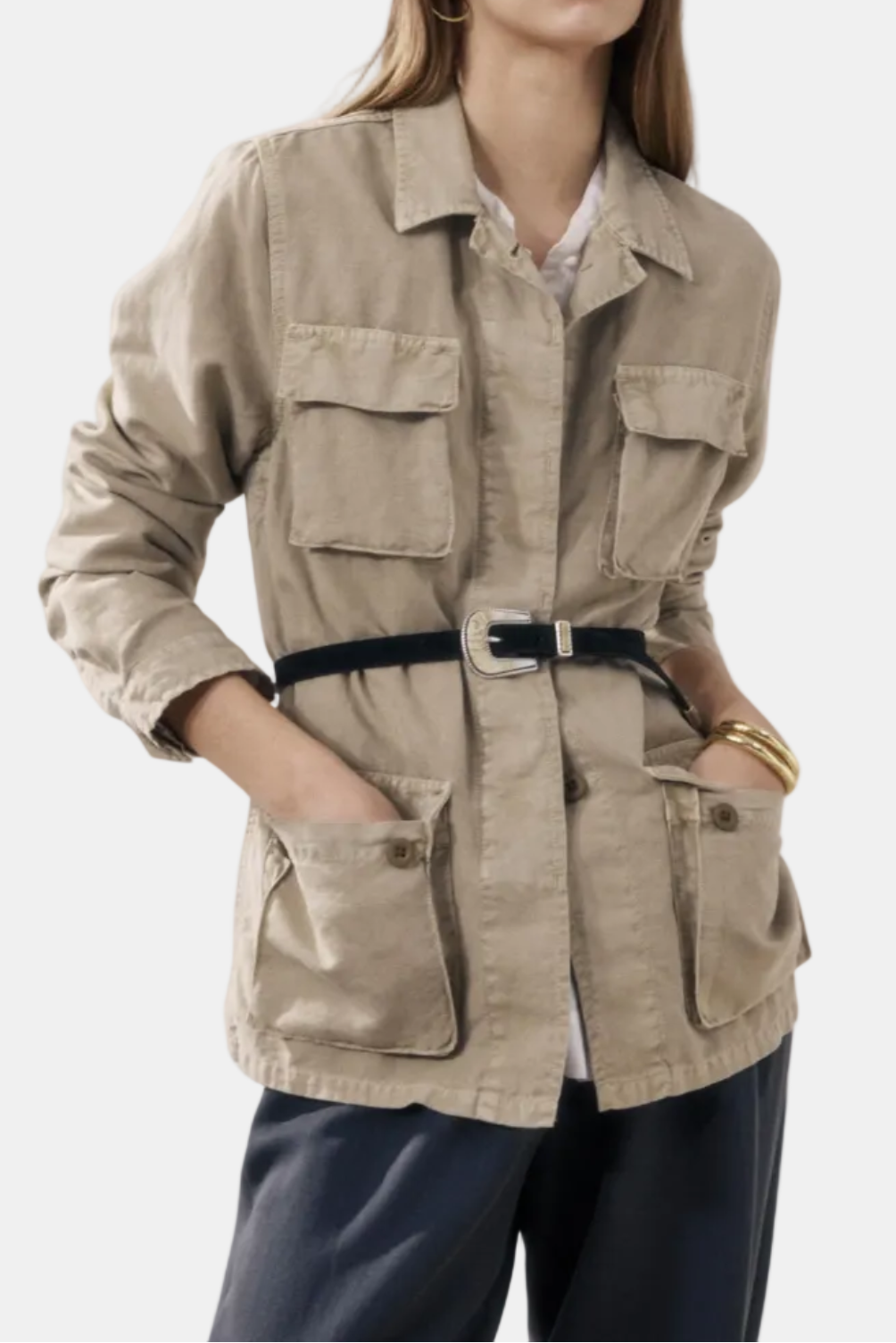 Woman wearing a beige safari jacket on a white background
