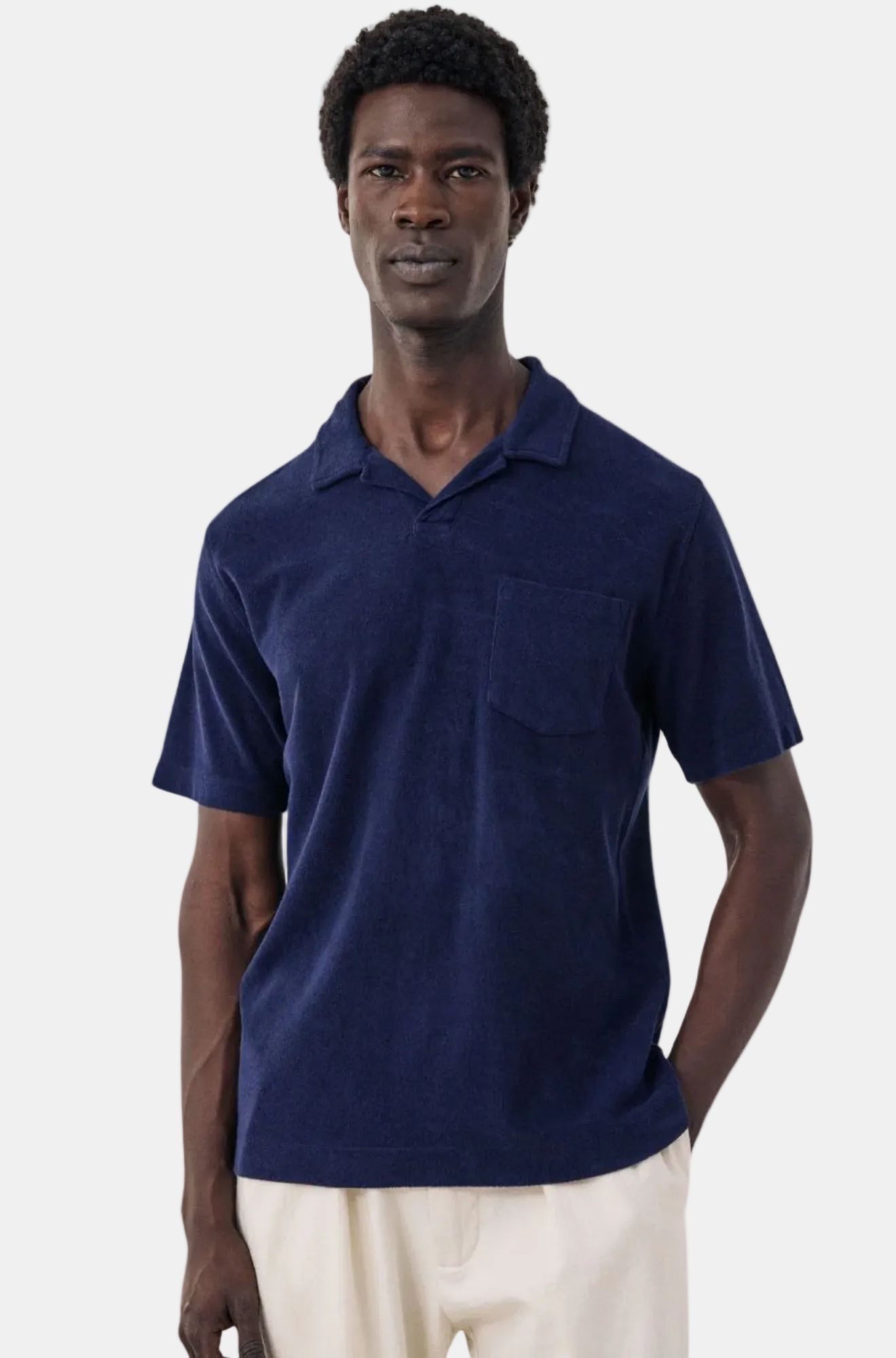 Man wearing a navy blue polo shirt on a white background