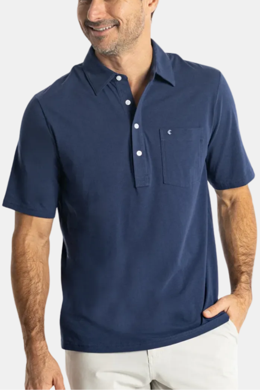Man wearing a navy blue polo shirt with a brand logo on a white background