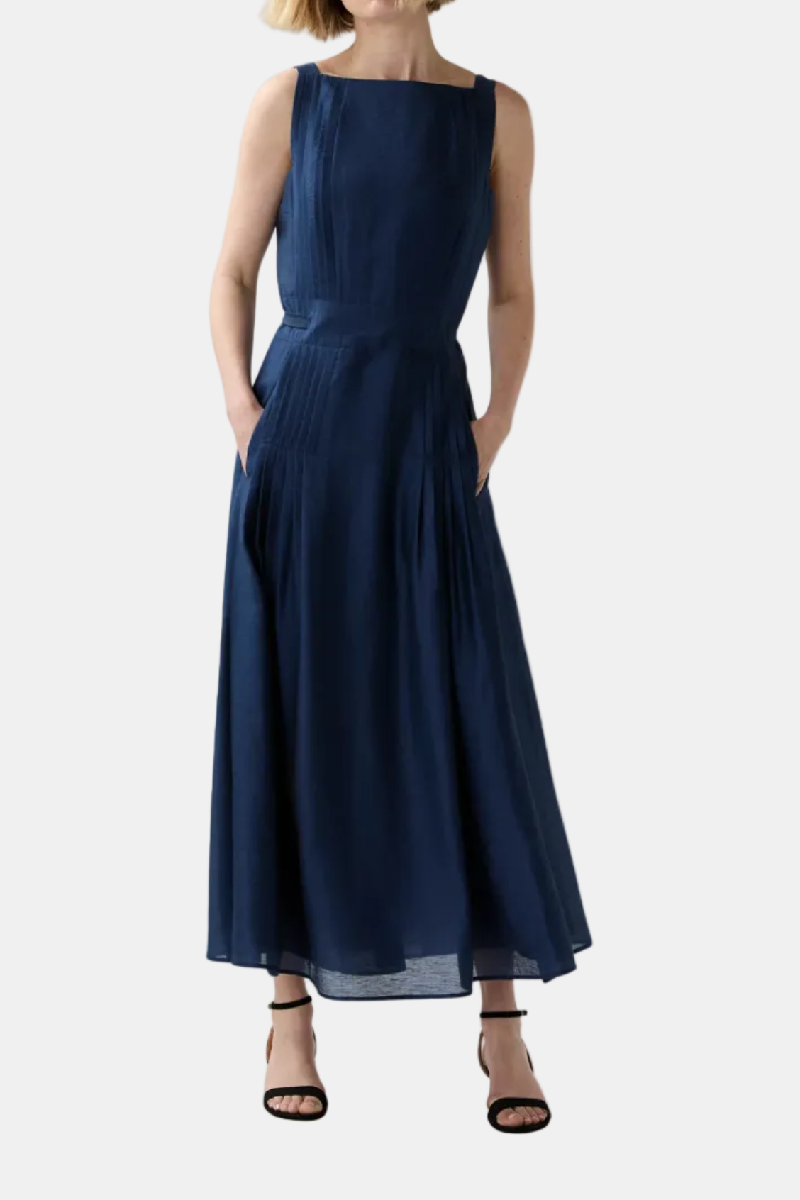 Woman wearing a navy blue dress on a white background