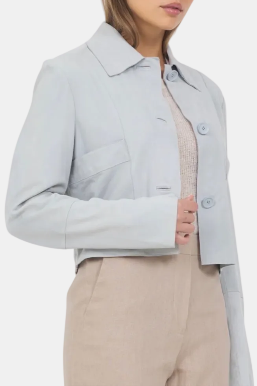 Woman wearing a light gray jacket on a white background