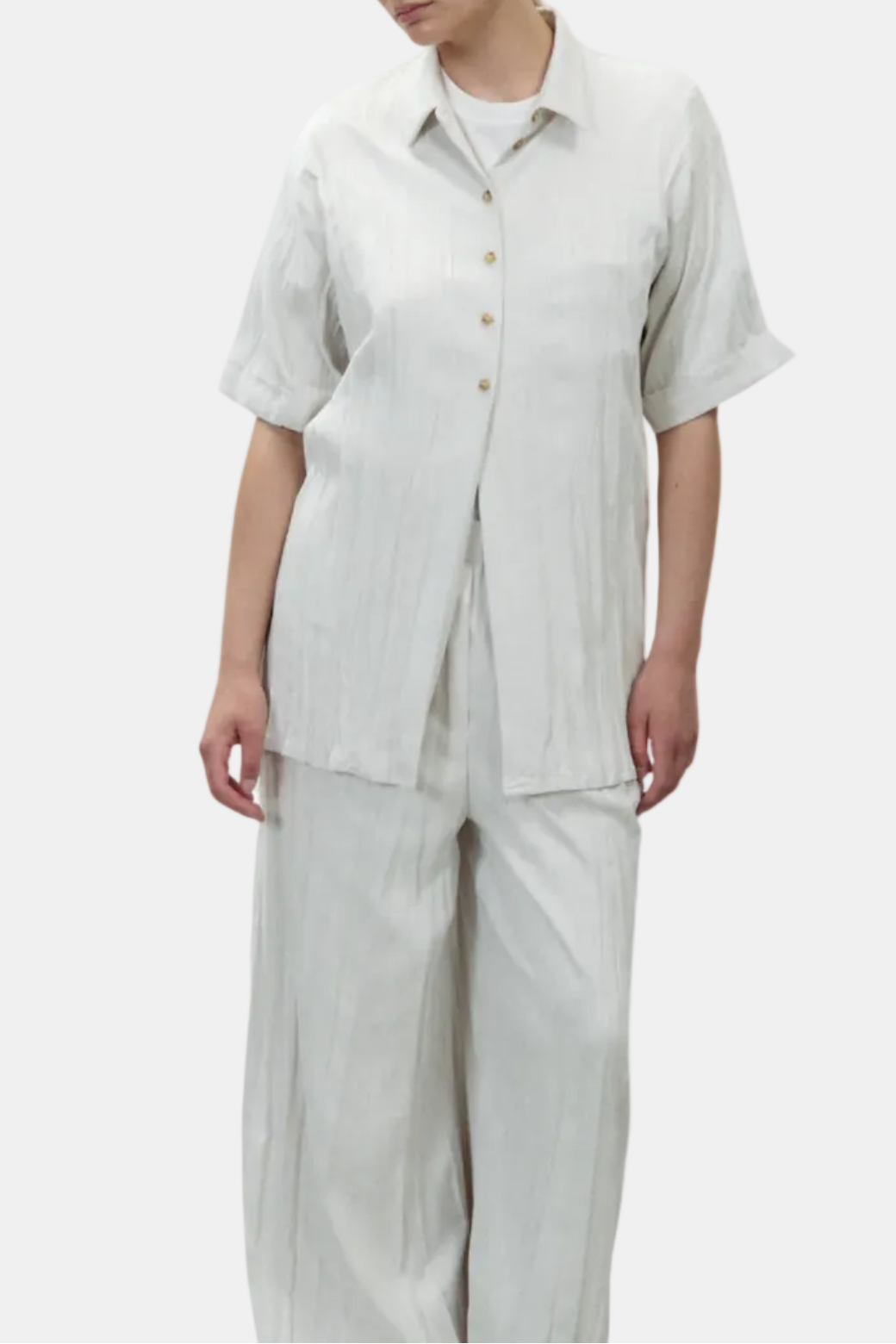 Woman wearing a light gray outfit on a white background