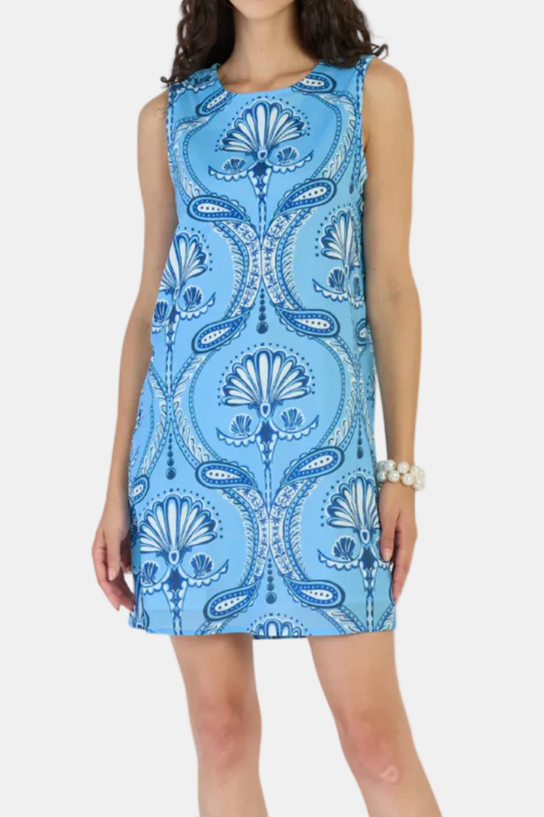 Woman wearing a blue patterned dress on a white background