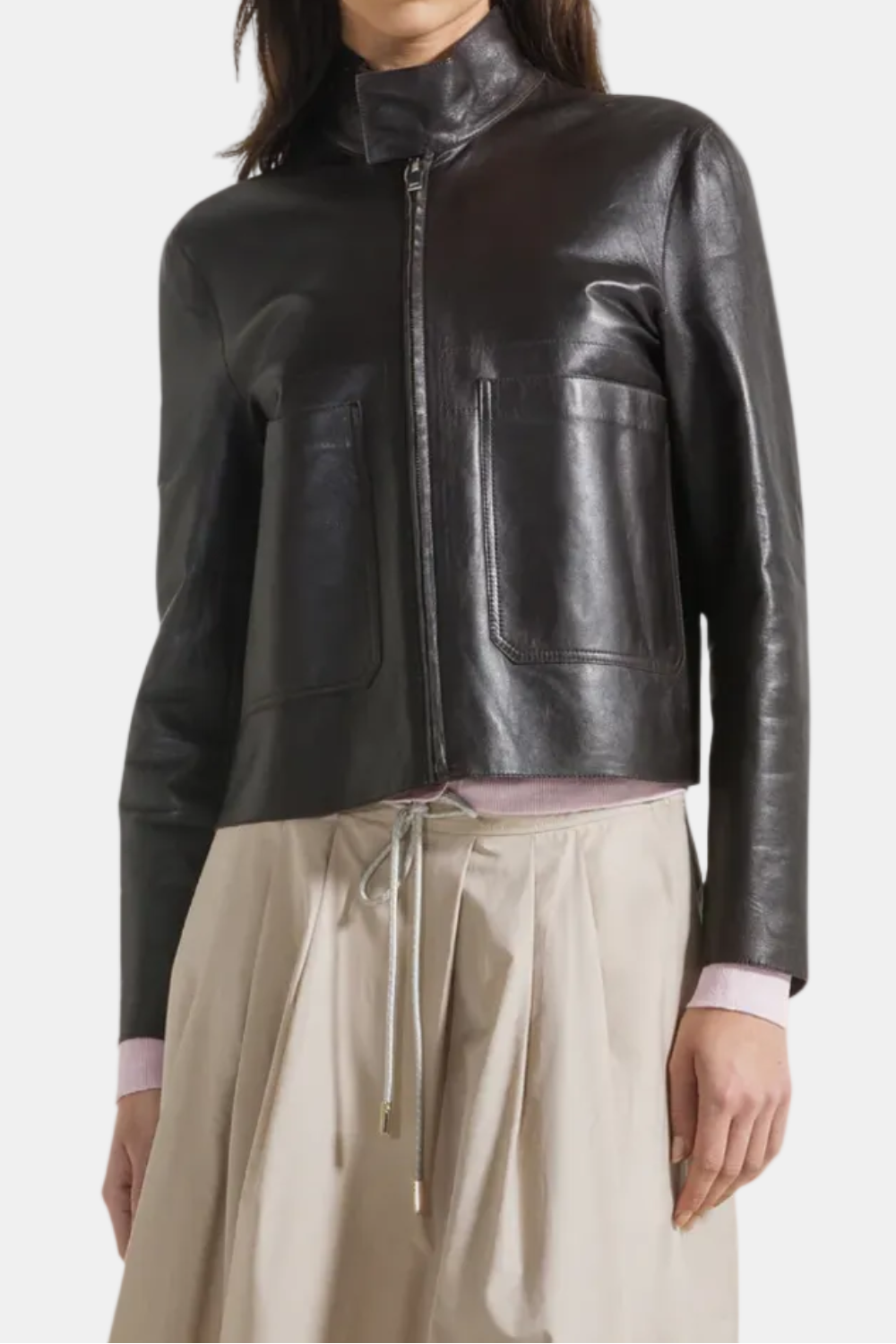 Woman wearing a black leather jacket on a white background