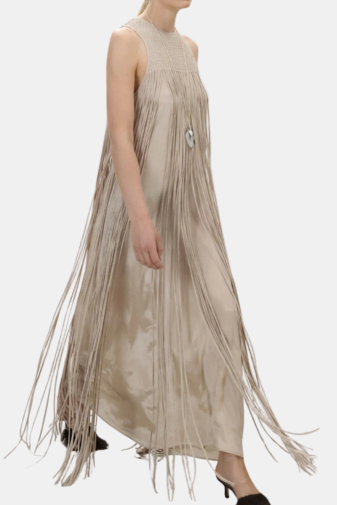 Woman wearing a beige fringe dress on a white background