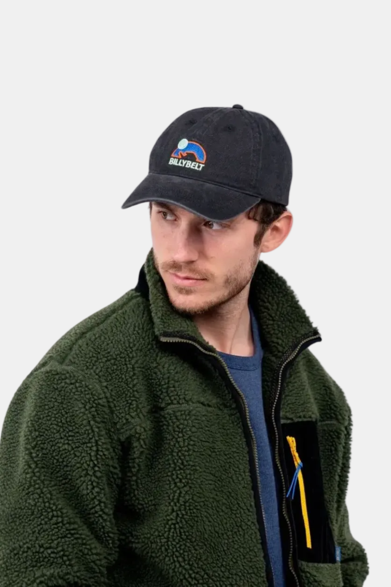 A person wearing a black cap with a logo on the front.