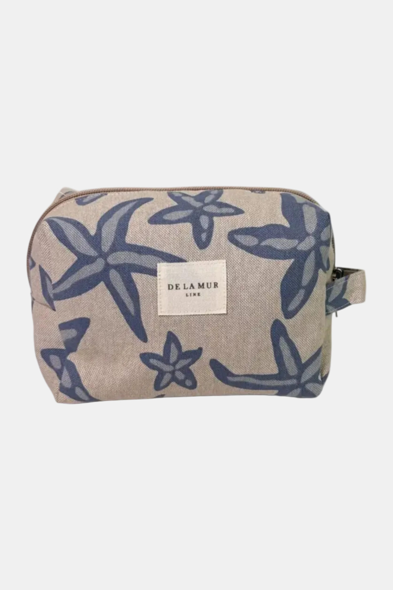 Cosmetic bag with starfish pattern and 'De La Mer' label on a white background