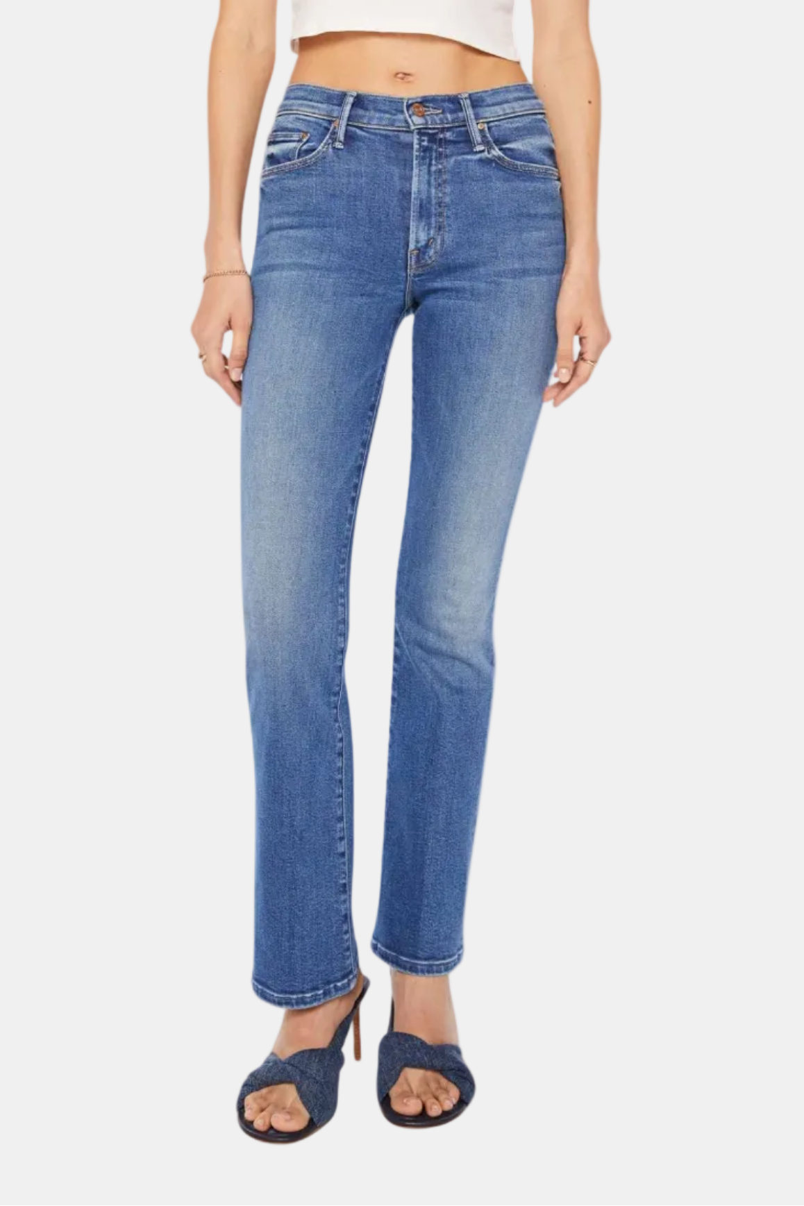 Person wearing blue jeans and a white top on a white background